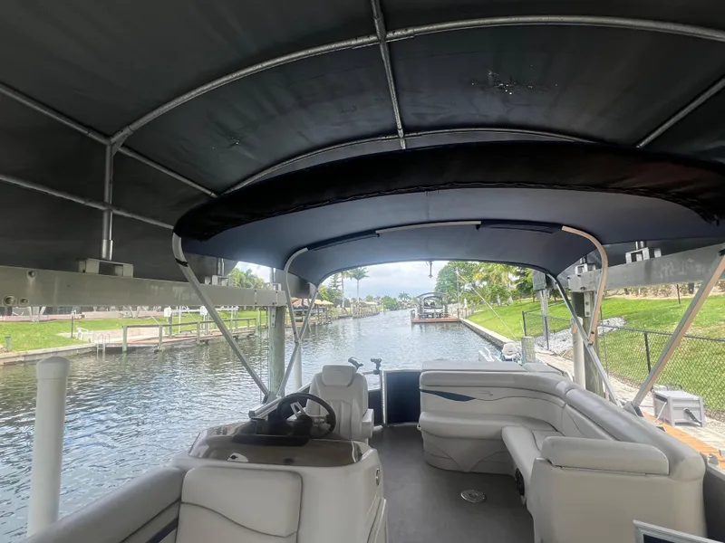 Slide: The Image of 2016 Bennington Sx pontoon boat with canopy on a calm canal. - 31