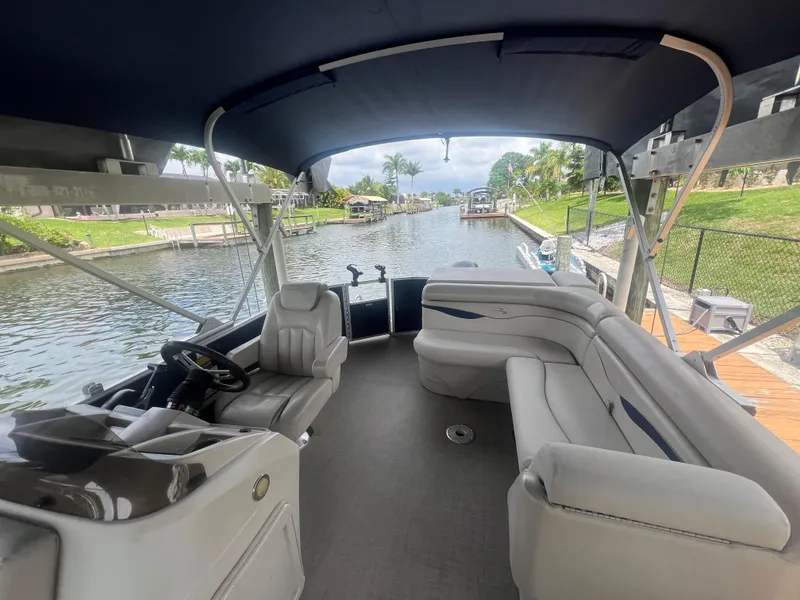 Slide: The Image of 2016 Bennington Sx pontoon boat interior on a scenic canal. - 6