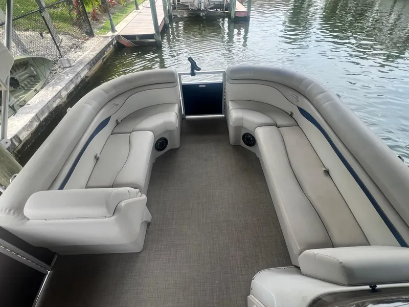 Slide: The Image of 2016 Bennington Sx pontoon boat interior with plush seating by the water. - 7