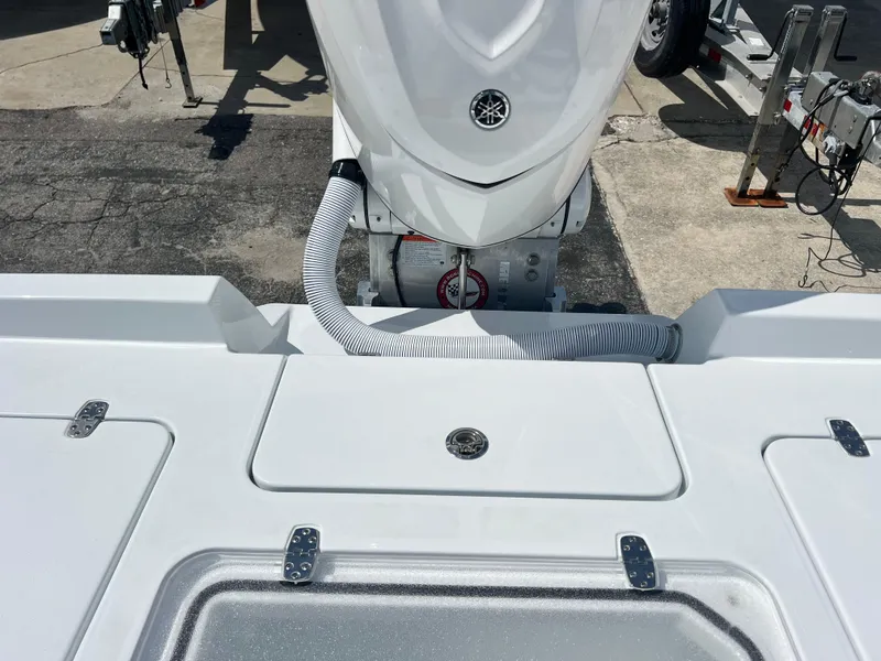 Slide: The Image of 2025 Contender 23 Bay boat stern with outboard motor and storage compartments. - 10