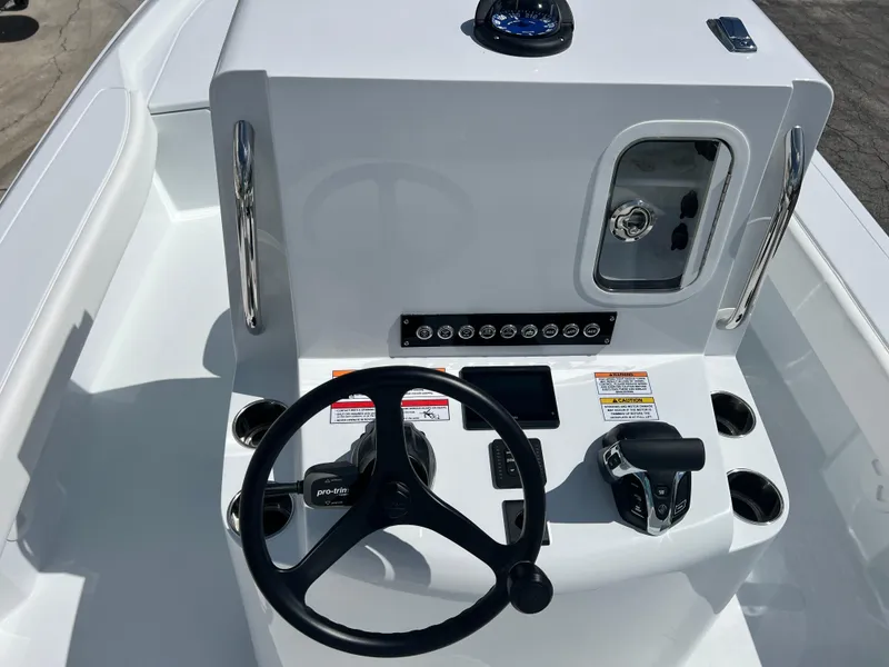 Slide: The Image of 2025 Contender 23 Bay boat console with steering wheel and controls. - 13