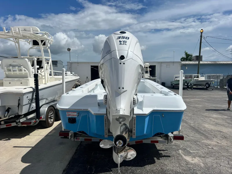 Slide: The Image of 2025 Contender 23 Bay boat with 350 HP engine, docked at marina. - 2