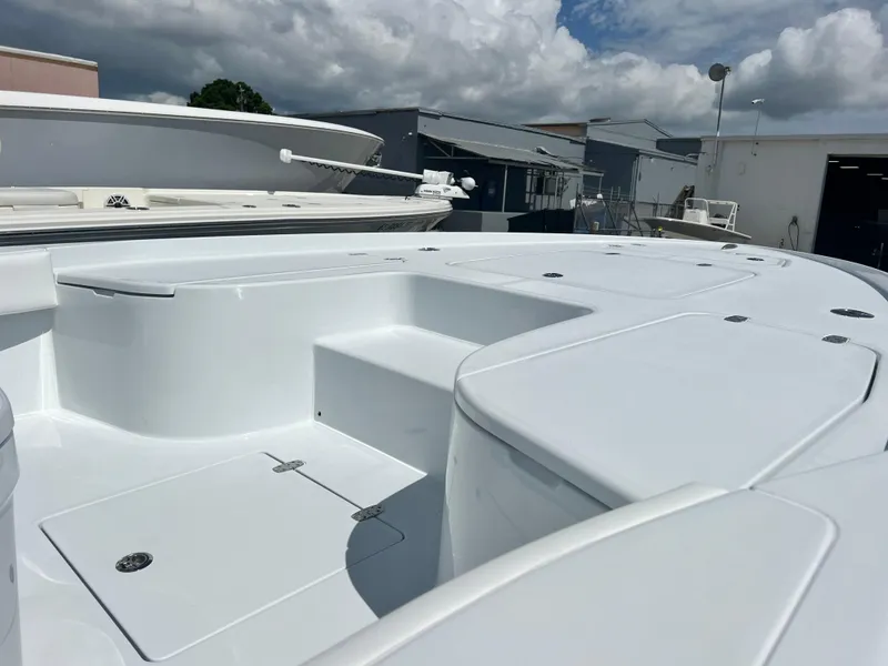 Slide: The Image of 2025 Contender 23 Bay boat deck with storage compartments and seating. - 4