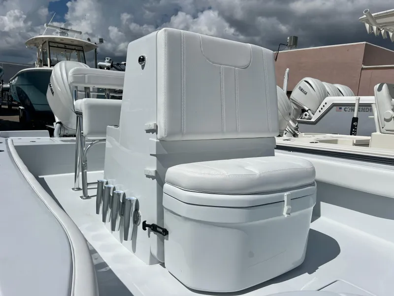 Slide: The Image of 2025 Contender 23 Bay boat interior with white seating and storage. - 5