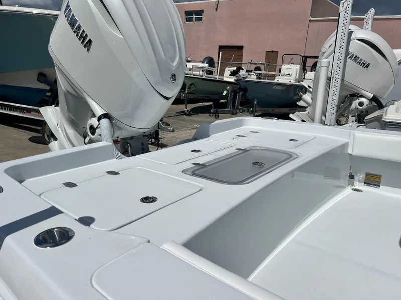 Slide: The Image of 2025 Contender 23 Bay boat with Yamaha outboard engines in a marina. - 8