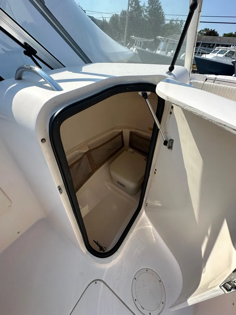 Slide: The Image of 2006 Grady-White 225 Tournament boat cabin interior with open door. - 11