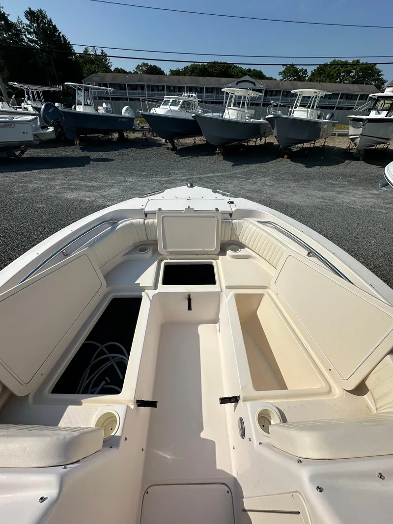 Slide: The Image of 2006 Grady-White 225 Tournament boat interior with open storage compartments. - 13