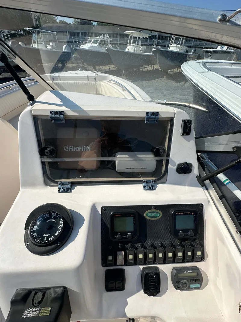 Slide: The Image of 2006 Grady-White 225 Tournament boat dashboard with gauges and controls. - 15