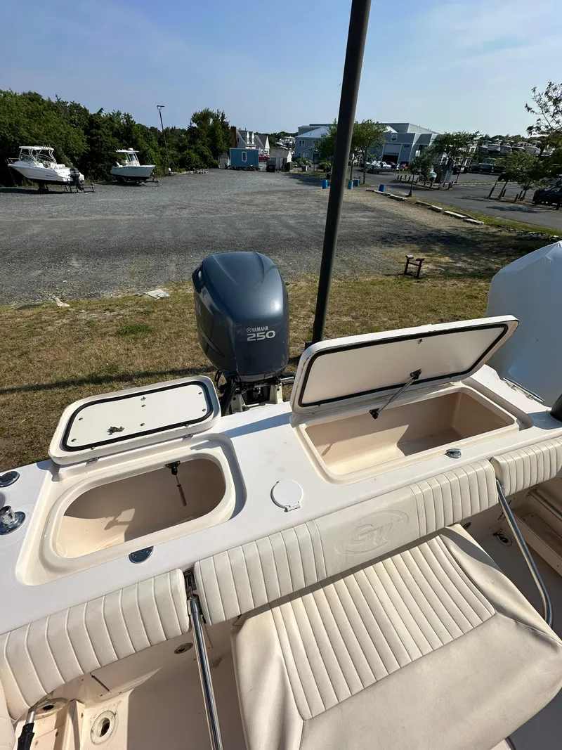 Slide: The Image of 2006 Grady-White 225 Tournament boat with open storage compartments and Yamaha 250 outboard motor. - 16