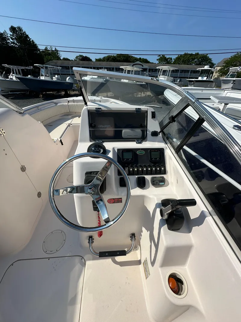 Slide: The Image of 2006 Grady-White 225 Tournament boat dashboard with steering wheel and controls. - 8