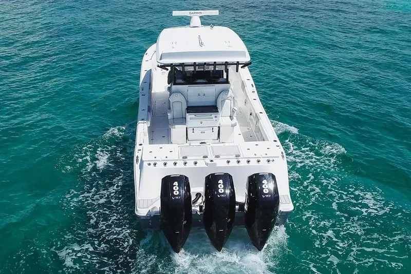 Slide: The Image of 2025 Sea Fox 368 Commander boat with triple 400 V10 engines on clear blue water. - 13
