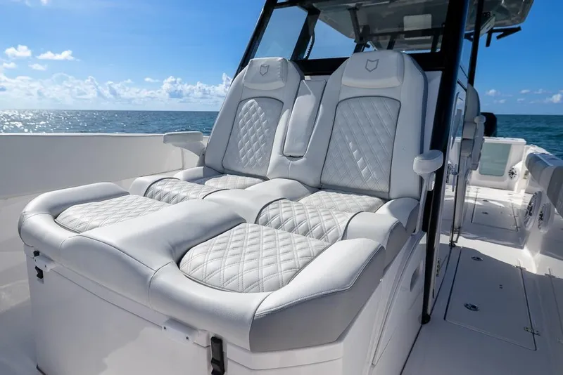 Slide: The Image of Luxurious seating on 2025 Sea Fox 368 Commander boat, ocean view in background. - 33