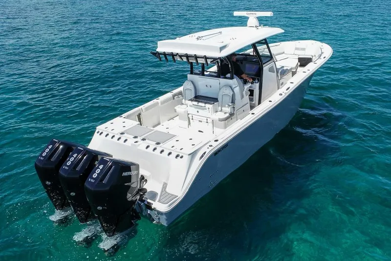 Slide: The Image of 2025 Sea Fox 368 Commander boat with triple Mercury engines on clear blue water. - 9