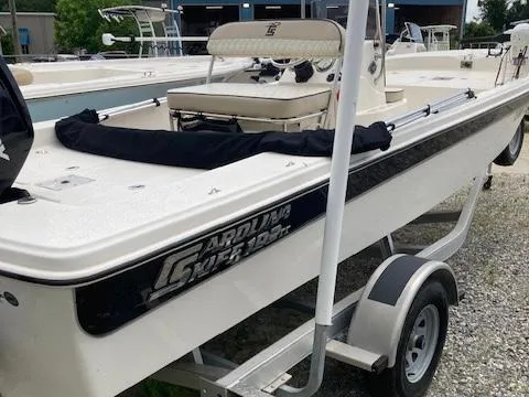 Slide: The Image of 2020 Carolina Skiff 19 JVS boat on trailer, white exterior, parked outdoors. - 4