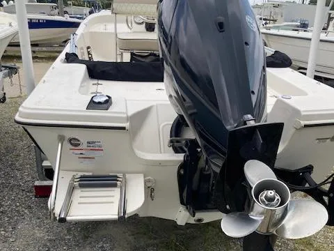 Slide: The Image of 2020 Carolina Skiff 19 JVS boat with outboard motor and swim ladder. - 6