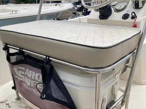 Slide: The Image of 2020 Carolina Skiff 19 JVS boat console with cushioned seat and storage. - 7