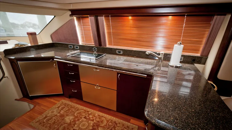 Slide: The Image of Luxurious kitchen interior of 2006 Sea Ray 58 Sedan Bridge yacht with granite countertops. - 4