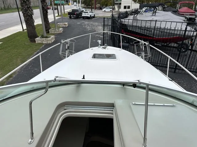 Slide: The Image of 1999 Sea Ray 270 Sundancer boat bow view with deck railing and hatch. - 13