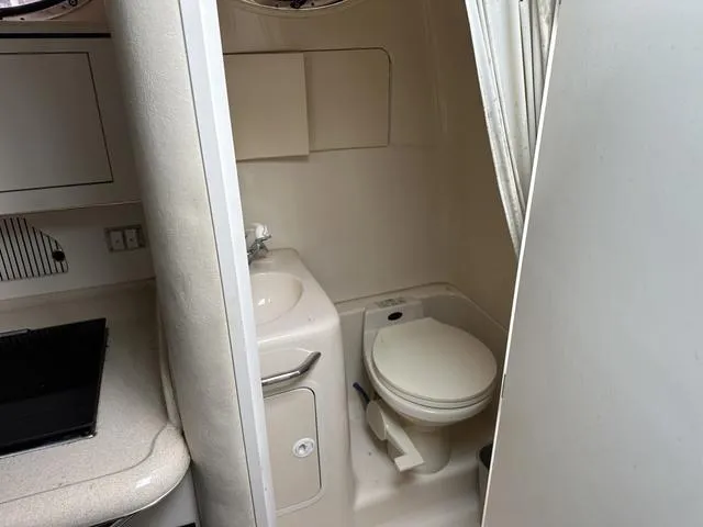 Slide: The Image of 1999 Sea Ray 270 Sundancer boat bathroom with sink and toilet. - 17
