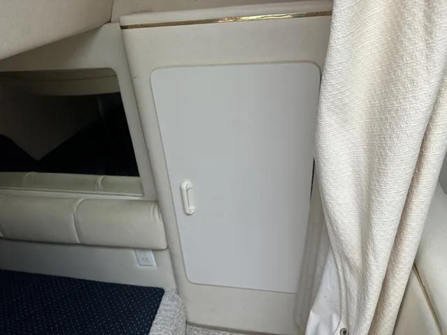 Slide: The Image of Interior cabin of a 1999 Sea Ray 270 Sundancer boat with storage compartment. - 20