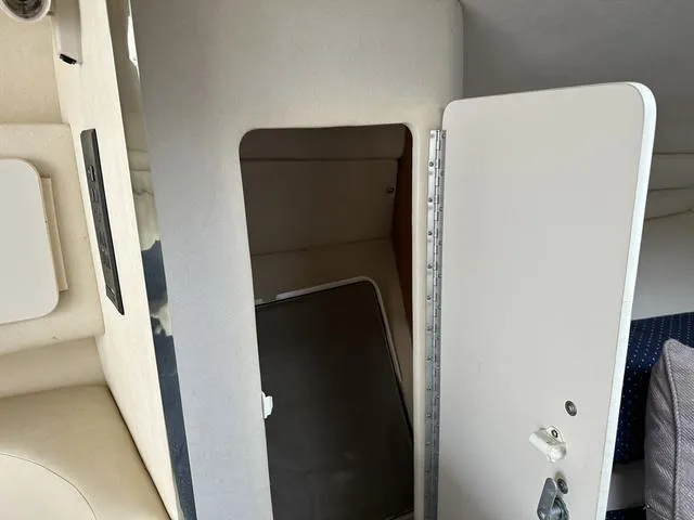 Slide: The Image of Interior cabin of a 1999 Sea Ray 270 Sundancer boat with open door. - 24