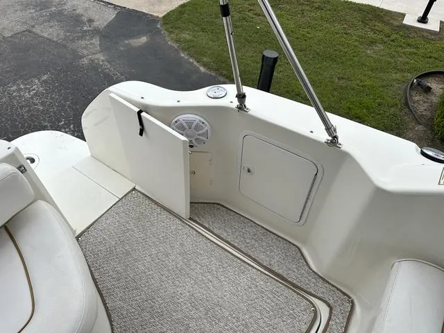Slide: The Image of 1999 Sea Ray 270 Sundancer boat deck with storage compartments and speaker. - 25