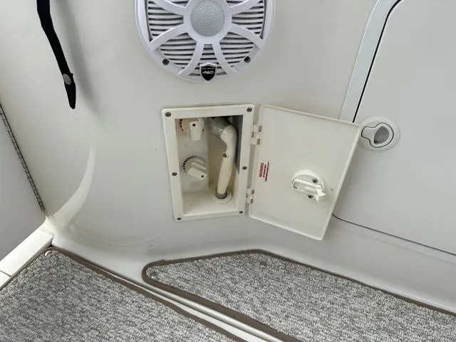 Slide: The Image of Open compartment on a 1999 Sea Ray 270 Sundancer boat with speaker and carpet. - 26
