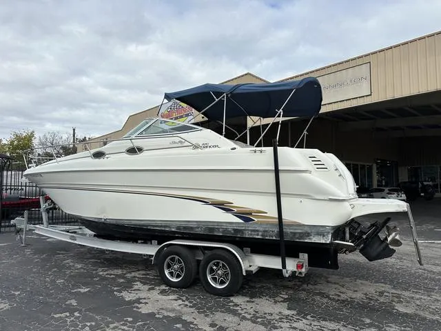 Slide: The Image of 1999 Sea Ray 270 Sundancer boat on a trailer with a blue canopy. - 4