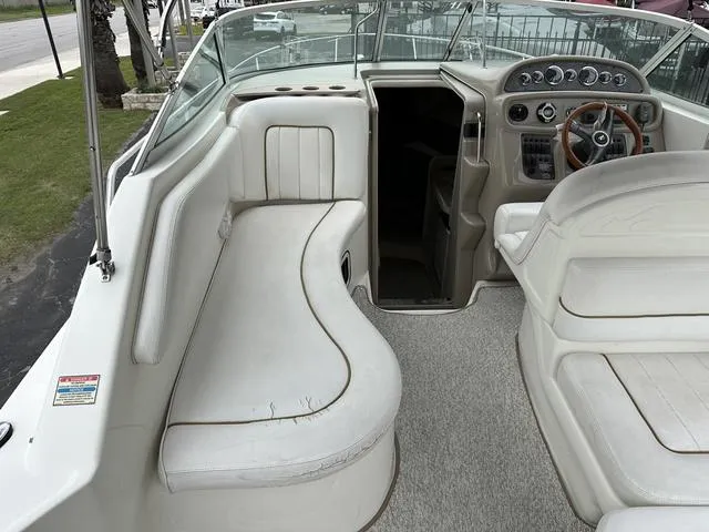 Slide: The Image of 1999 Sea Ray 270 Sundancer boat interior with seating and control panel. - 9