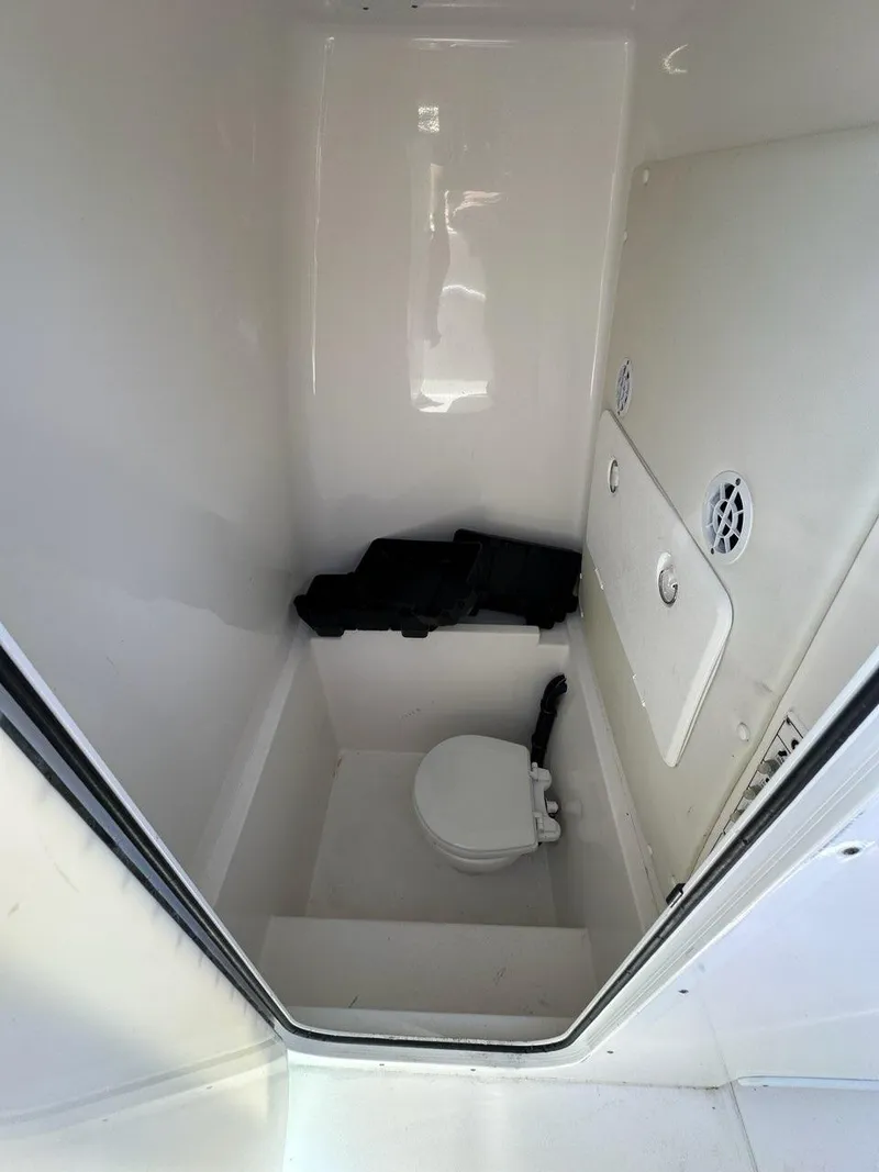 Slide: The Image of 2013 Contender 28 Tournament boat interior with toilet and storage compartment. - 11