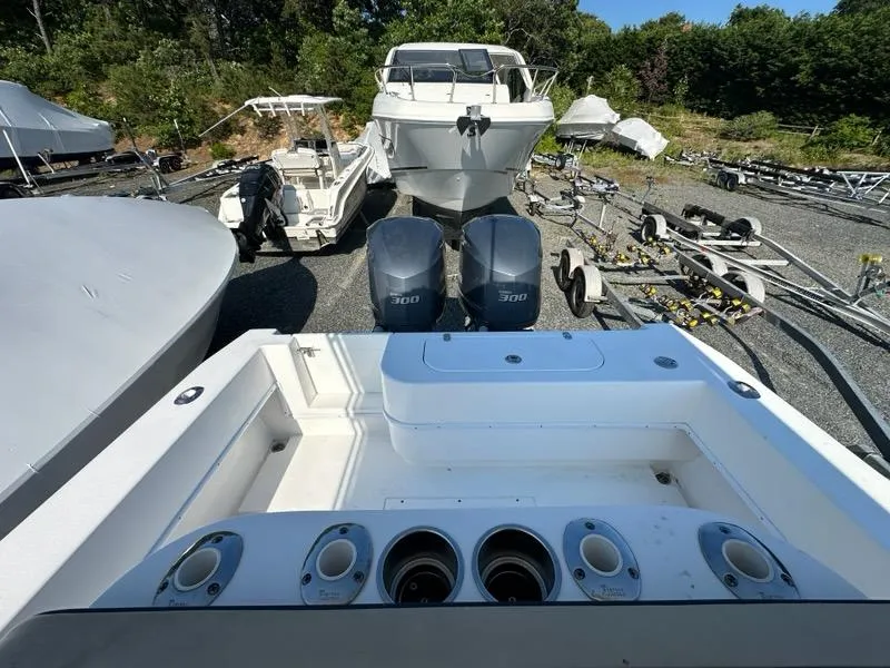 Slide: The Image of 2013 Contender 28 Tournament boat with twin 300 HP engines in a storage yard. - 17
