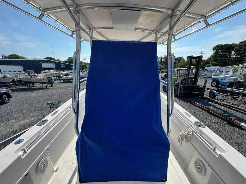 Slide: The Image of 2013 Contender 28 Tournament boat with blue cover, docked in a marina. - 6