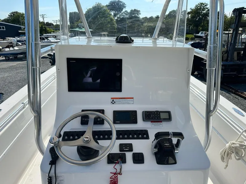 Slide: The Image of 2013 Contender 28 Tournament boat console with steering wheel, controls, and navigation screen. - 9