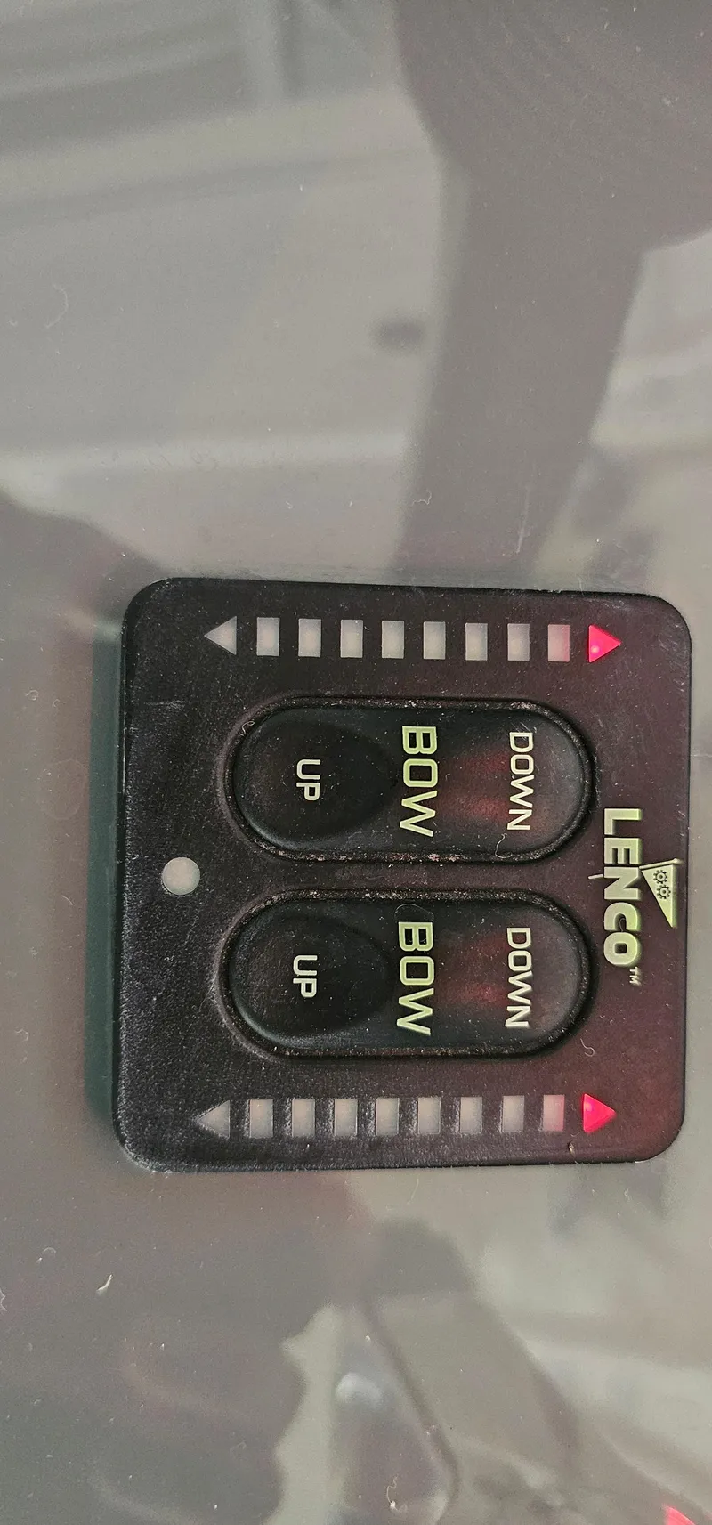 Slide: The Image of Lenco trim tab control panel on a 2014 Pursuit C 260 Center Console boat. - 18