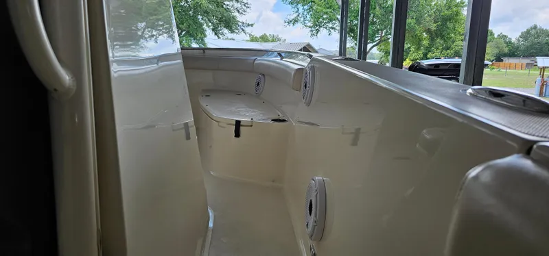 Slide: The Image of 2014 Pursuit C 260 Center Console boat interior with seating and speakers. - 19