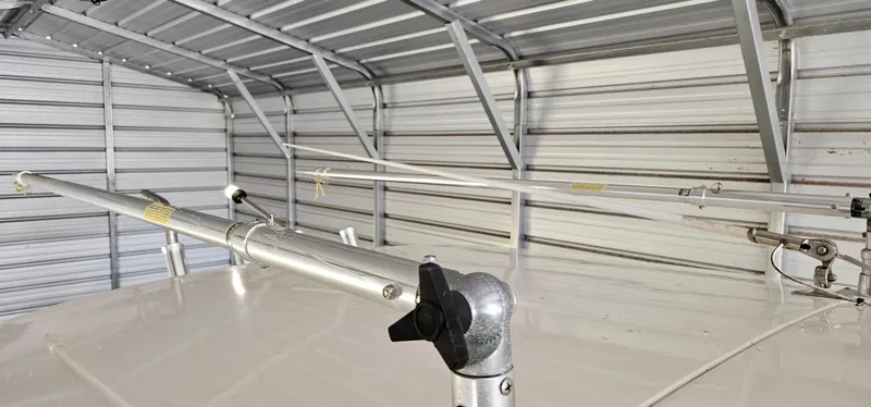 Slide: The Image of 2014 Pursuit C 260 Center Console boat stored in a metal garage. - 20