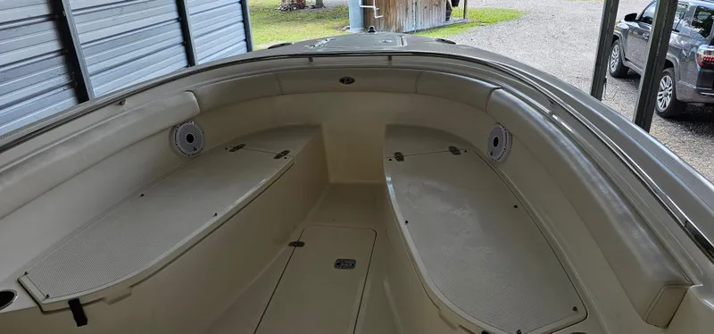 Slide: The Image of 2014 Pursuit C 260 Center Console boat interior with seating and storage compartments. - 9