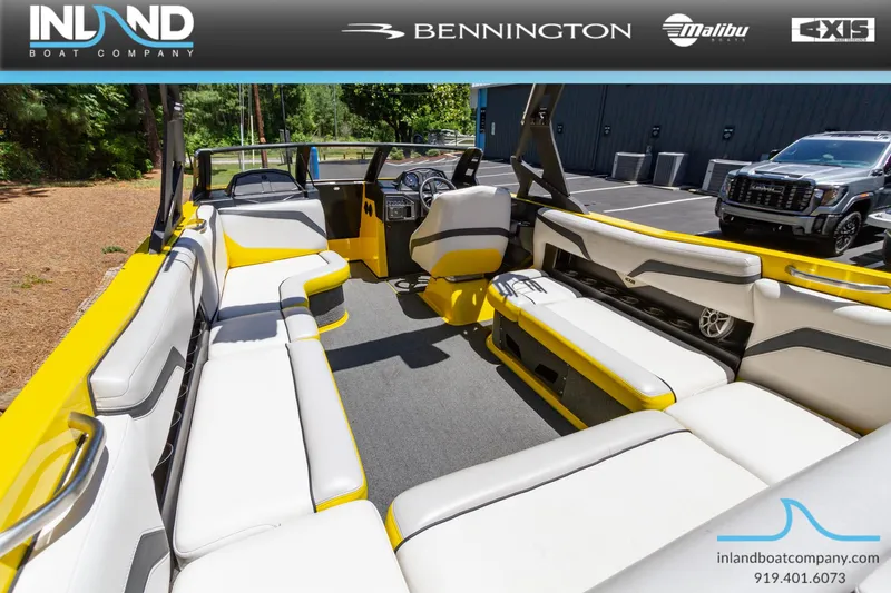 Slide: The Image of 2016 Axis T23 boat interior with white and yellow seating, displayed by Inland Boat Company. - 10