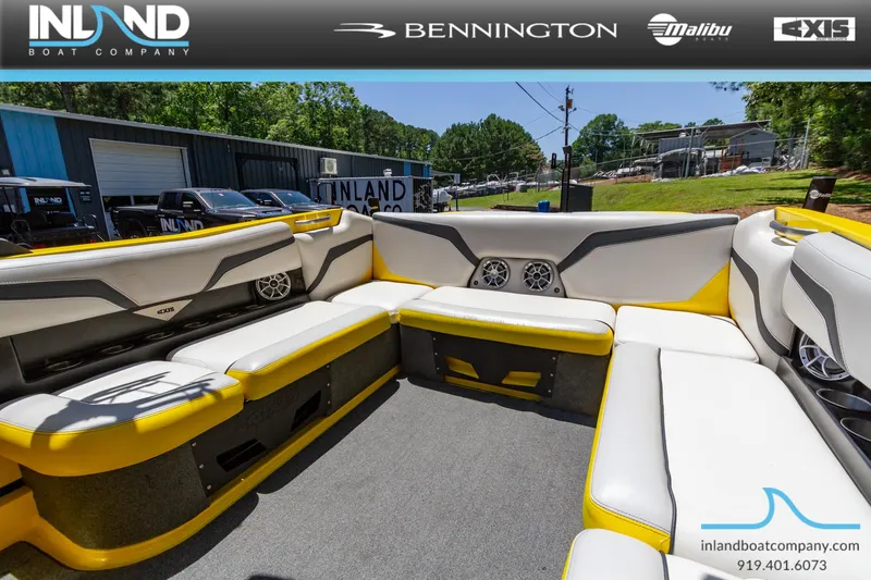 Slide: The Image of 2016 Axis T23 boat interior with yellow and white seating at Inland Boat Company. - 13