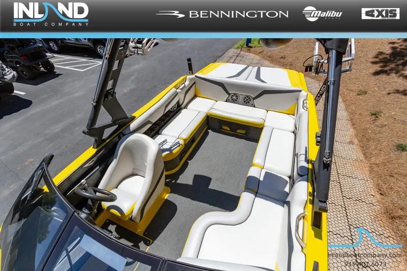 Slide: The Image of 2016 Axis T23 boat interior with yellow and white seating, displayed by Inland Boat Company. - 16
