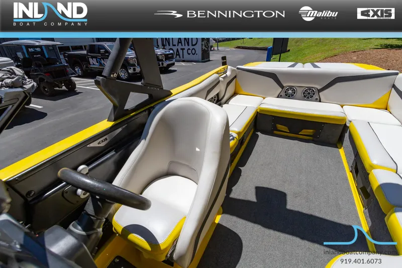 Slide: The Image of 2016 Axis T23 boat interior with yellow and white seating, displayed by Inland Boat Company. - 17