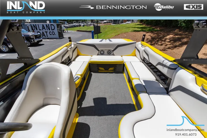 Slide: The Image of 2016 Axis T23 boat interior with yellow and white seating at Inland Boat Company. - 18