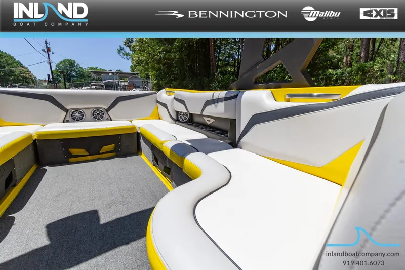 Slide: The Image of 2016 Axis T23 boat interior with yellow and white seating, showcased by Inland Boat Company. - 19