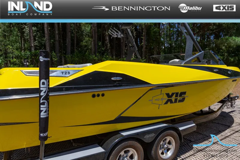 Slide: The Image of 2016 Axis T23 yellow boat on trailer at Inland Boat Company. - 2