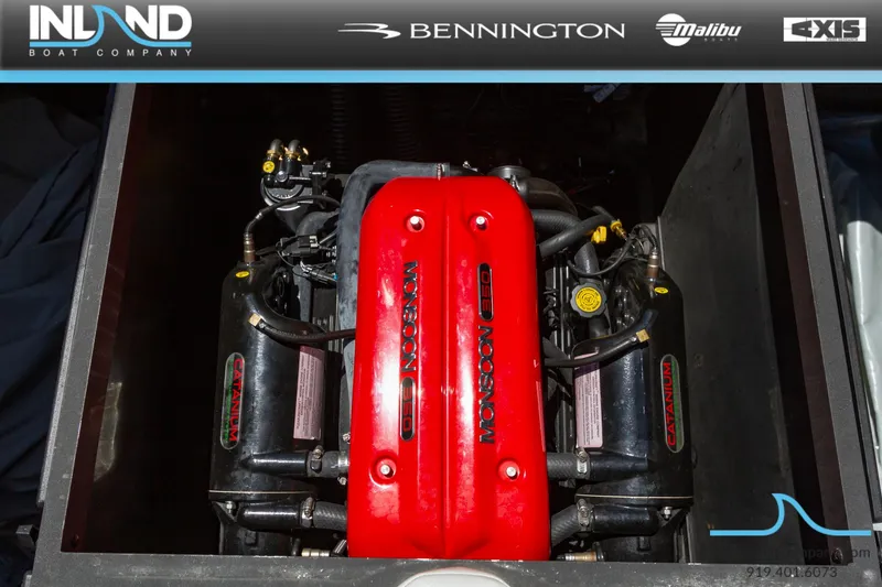 Slide: The Image of 2016 Axis T23 boat engine with red cover, displayed by Inland Boat Company. - 20