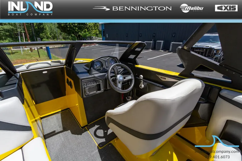 Slide: The Image of 2016 Axis T23 boat interior with yellow and gray seating, steering wheel, and dashboard. - 6