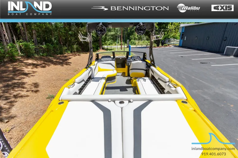 Slide: The Image of 2016 Axis T23 boat interior with yellow and white seating, displayed by Inland Boat Company. - 8