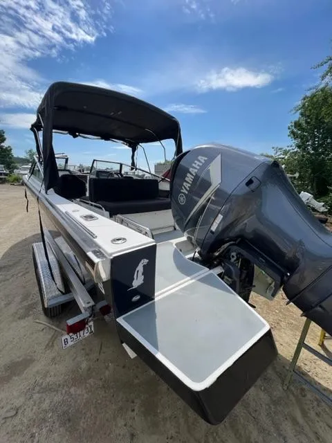 Slide: The Image of 2016 Draco 27 RS boat with Yamaha outboard motor, docked on a sunny day. - 14