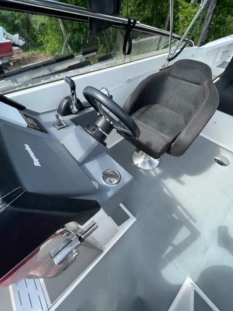 Slide: The Image of 2016 Draco 27 RS boat cockpit with steering wheel and captain's chair. - 16