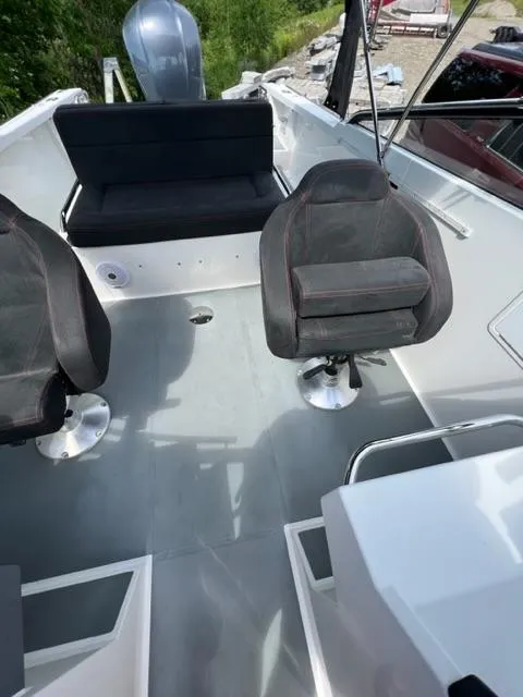 Slide: The Image of 2016 Draco 27 RS boat interior with seating and steering area. - 17